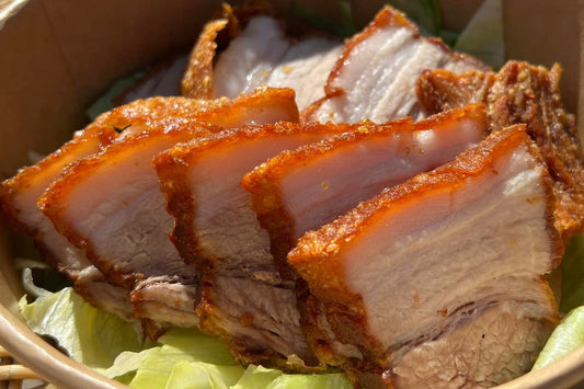 Sliced roasted pork in a bowl with lettuce Filipino lechon kawali 